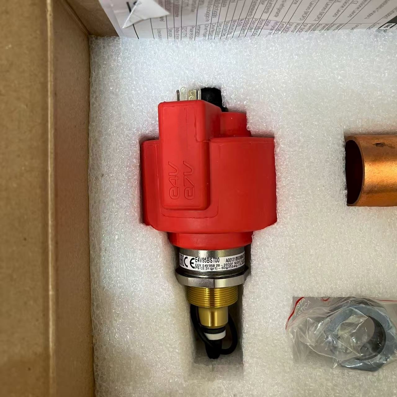 Close-up of red coil with model E4V95BST00 on the valve body label.