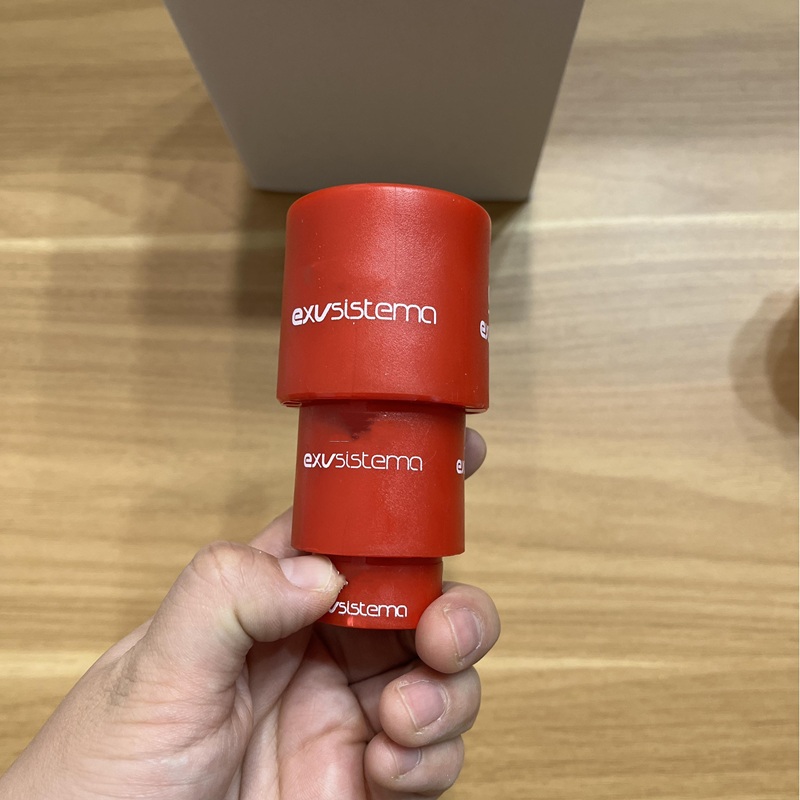Actuator held in hand, showing multi-size magnetic adapters