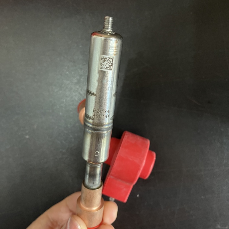 Close-up of valve body with model E2V24BSM00 and QR code
