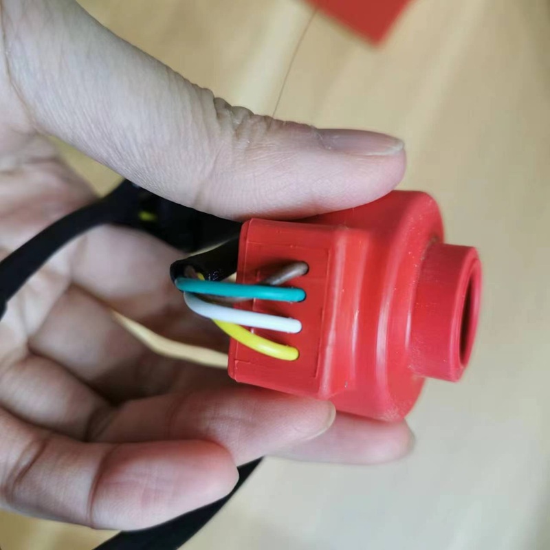 Close-up of wiring terminal on red coil