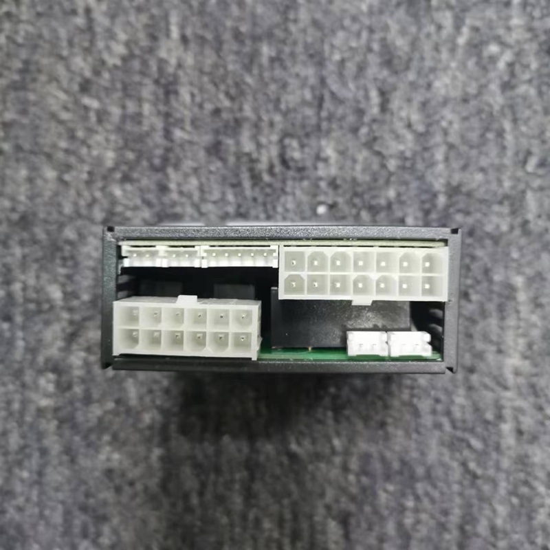 Rear side of temperature controller with multiple groups of white plug-in wiring ports