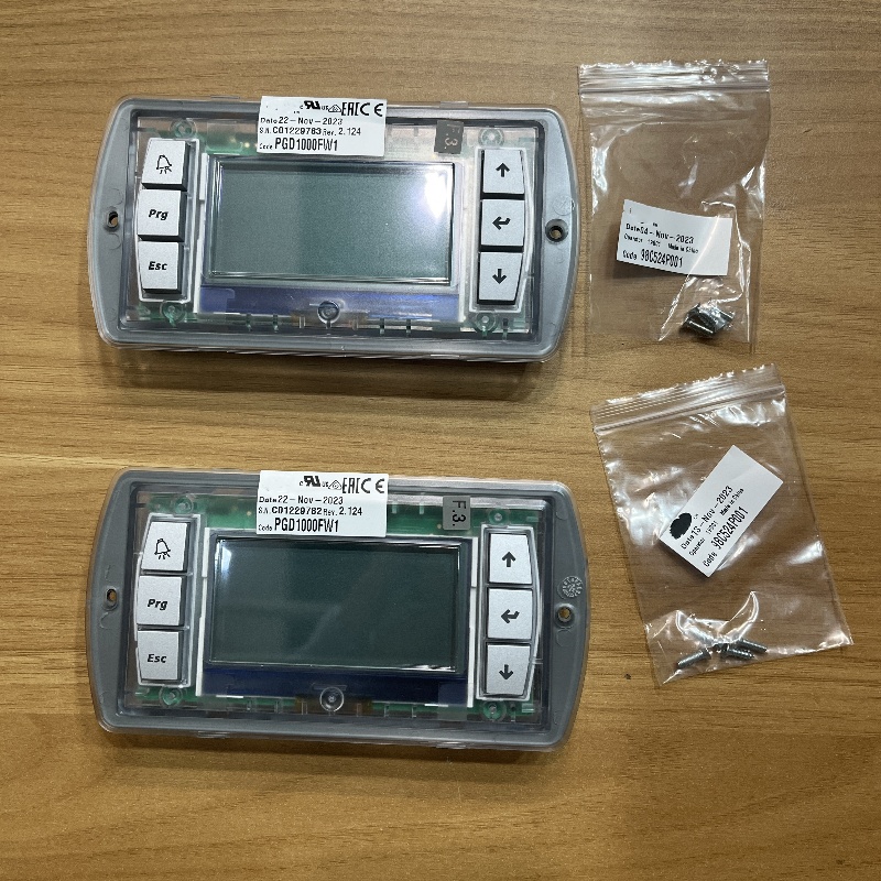 Two industrial operator panels with LCD displays and keypad buttons,