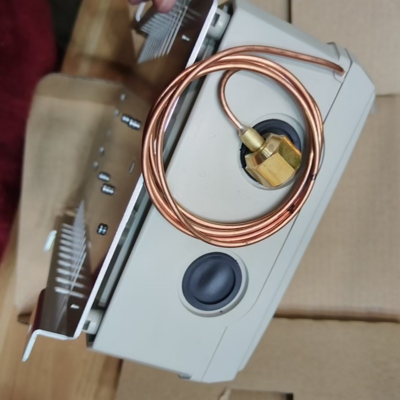 Front side of unit, copper sensing capillary and brass pressure fitting exposed