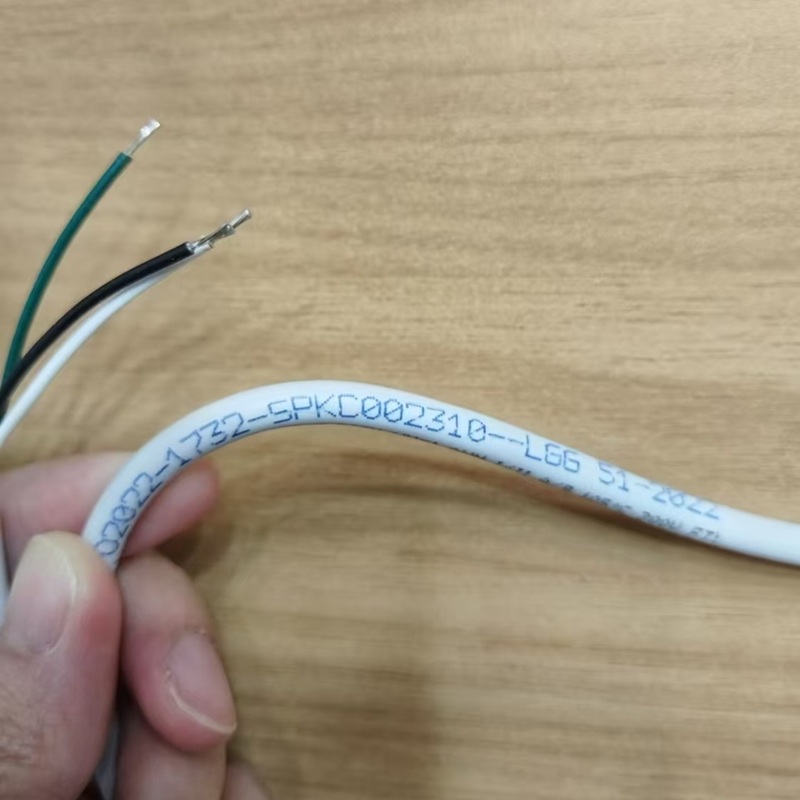 Close-up of the cable with model marking, showing three colored conductors.