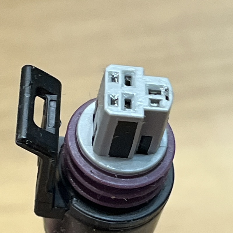 Connector close-up, showing internal pins and purple sealing ring.