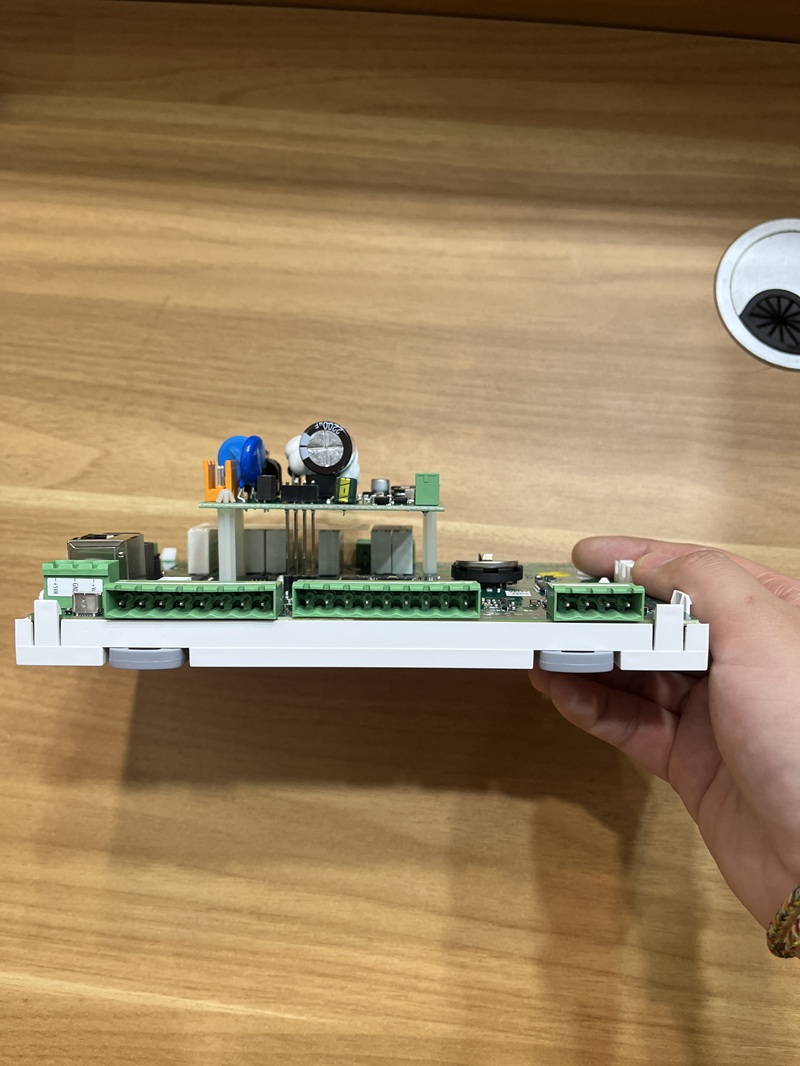 Side view of the industrial control mainboard held in hand