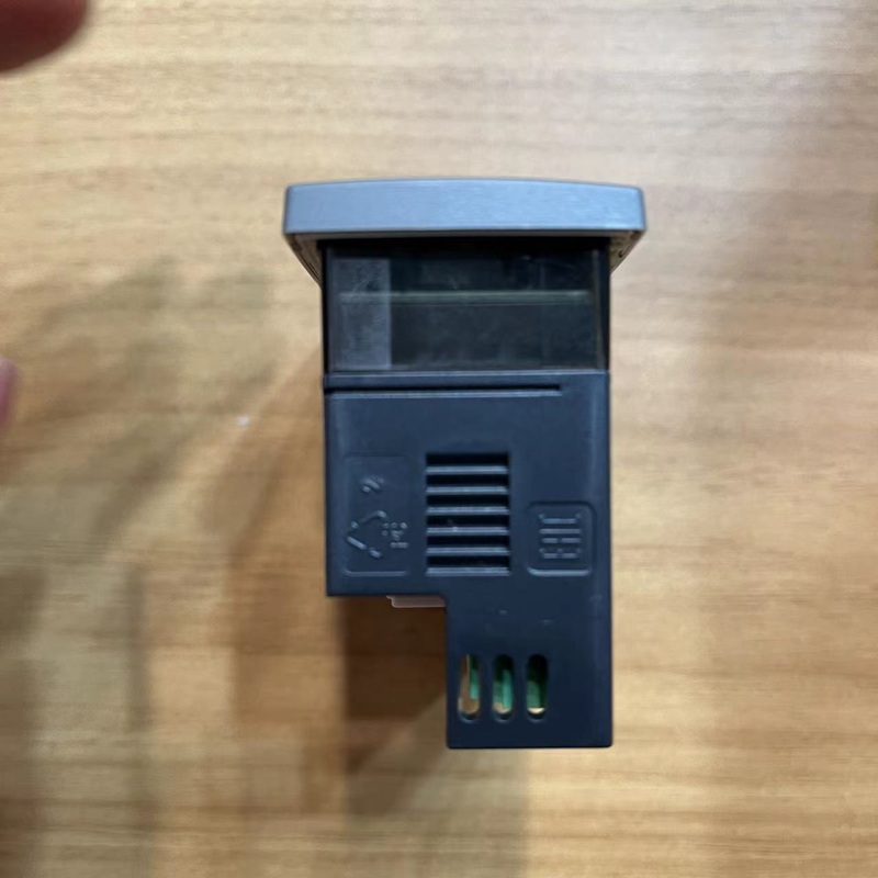 Side view of the temperature controller with ventilation slots.