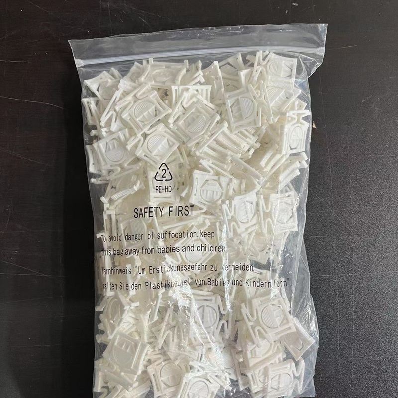 A bag of white plastic clip accessories.