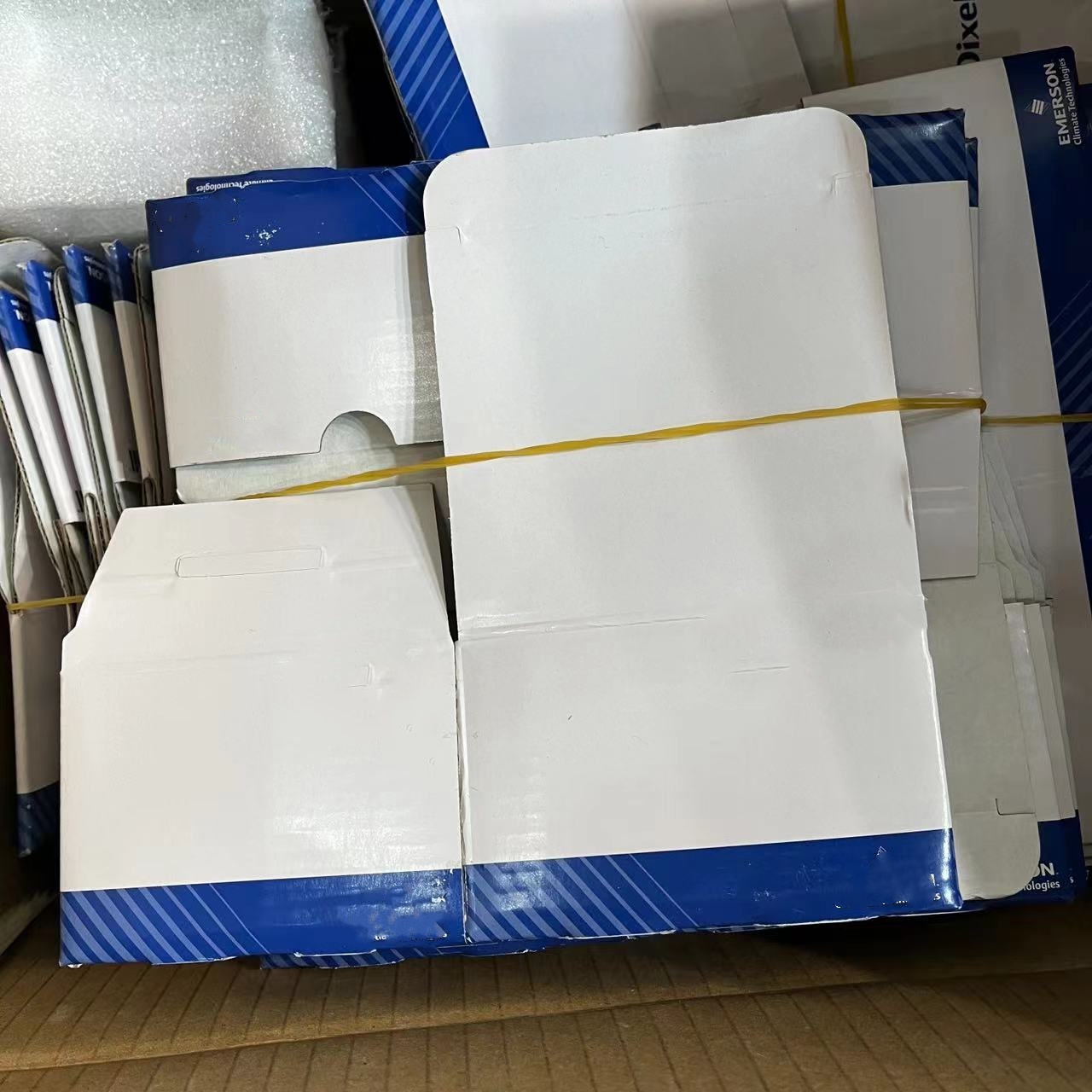 Stacked product packaging boxes in blue and white.