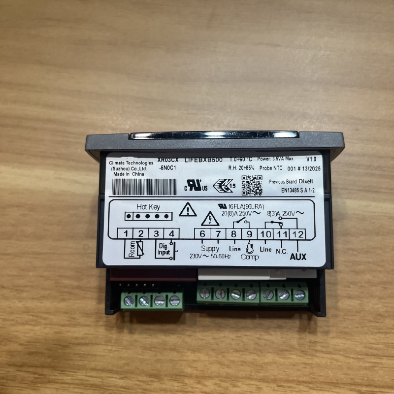 Back nameplate of temperature controller marked with specs and terminal diagram