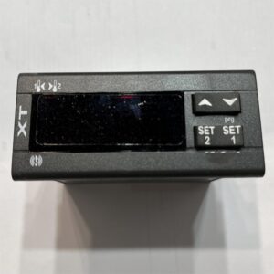 Thermostat front view: with XT logo, digital display and 4 operation buttons
