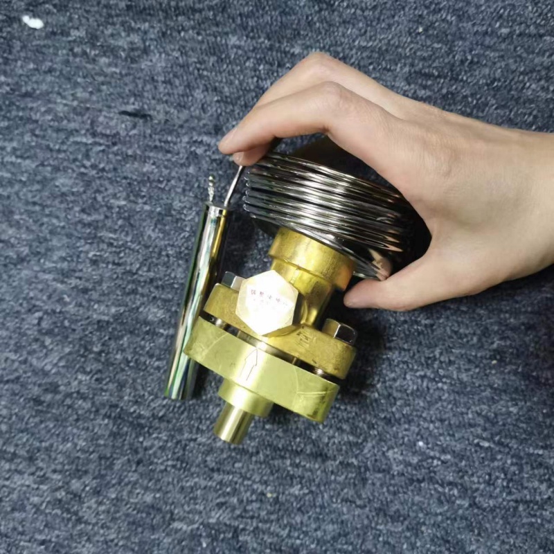 Overall shot of brass valve body with long temperature tube held in hand