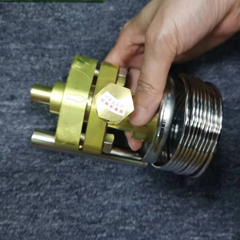 Hand-held valve body showing hexagonal flow adjustment bolt with sticker