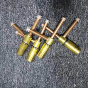Four hot gas bypass valves laid flat, copper pipe ends with plastic dust caps